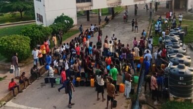 Student residents at Indy Hall queuing for water pumped with generator