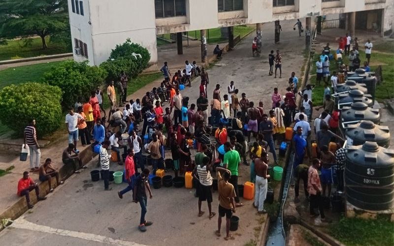 Student residents at Indy Hall queuing for water pumped with generator